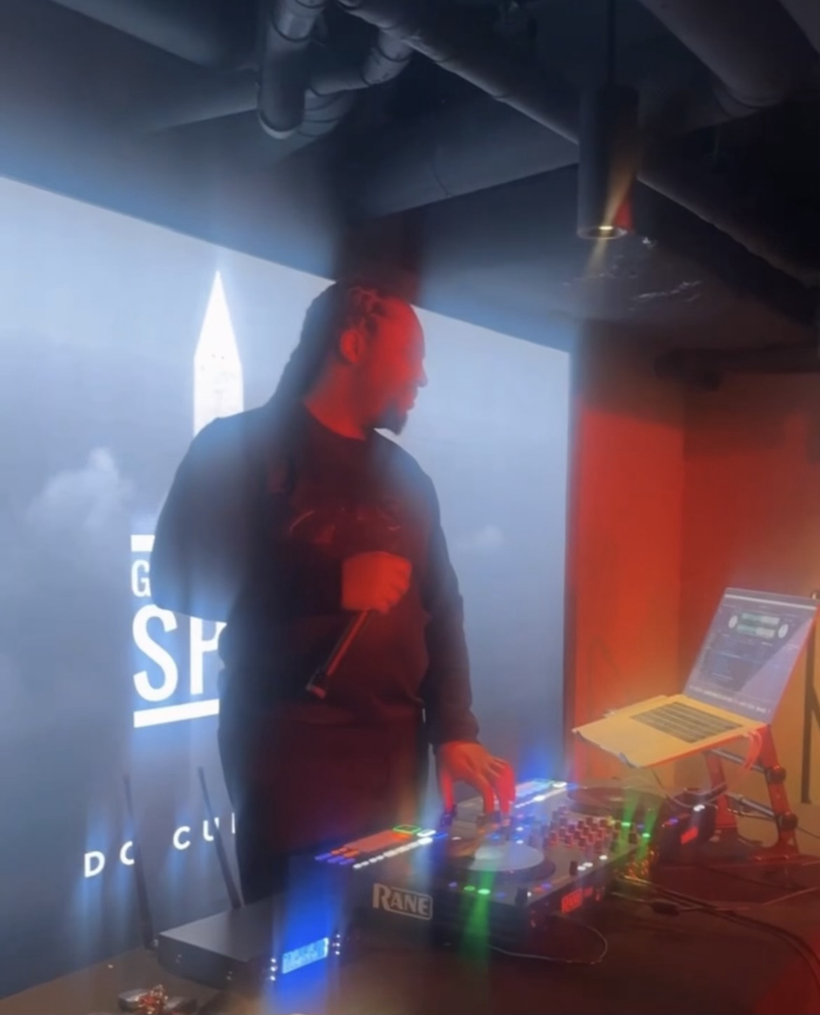 DJ Jumpman on the decks behind a Rane controller, mixing live